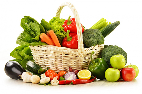 Composition with raw vegetables and wicker basket isolated on white